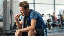 Load image into Gallery viewer, Male Athlete eating Jones Bar Organic Peanut Butter Bar