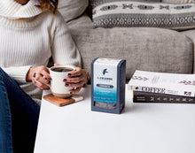 Load image into Gallery viewer, Woman enjoying La Colombe Corsica Coffee
