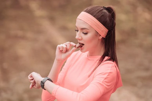 Woman after workout eating Jonesbar Dark Chocolate Almond bar
