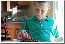 Load image into Gallery viewer, Bazzini Dark Chocolate Coconut Almonds child snacking