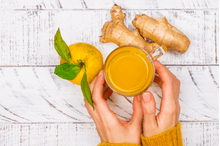 Load image into Gallery viewer, Republic of Tea Organic Turmeric Ginger Green Tea in hands