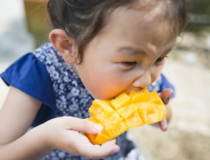 Child happily eating Jones Bar Mango 